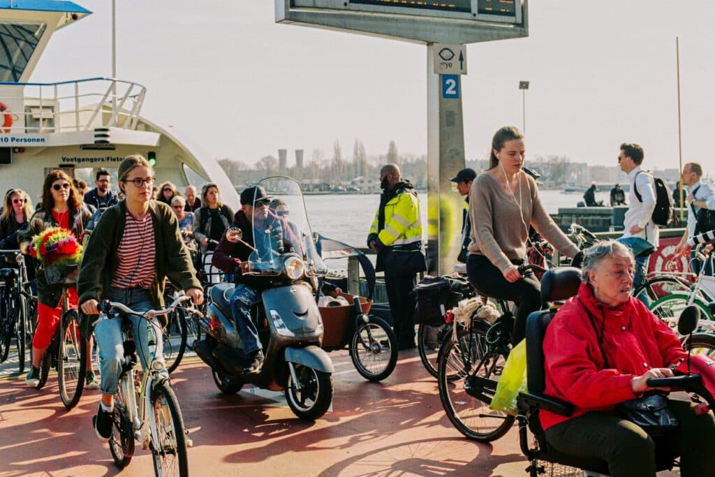 people commute in amsterdam people listening to Dutch podcast while commuting near Amsterdam central station