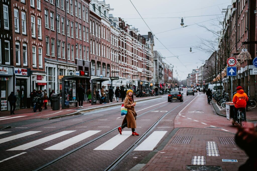 ams_street local walking across street in downtown Amsterdam